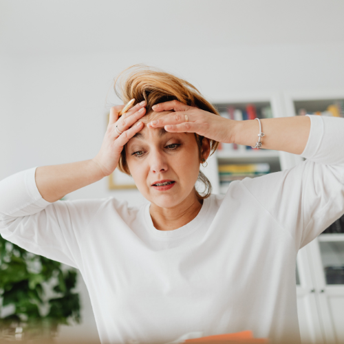 Person holding their jaw in discomfort